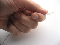 hold the tip of the thread in your left hand