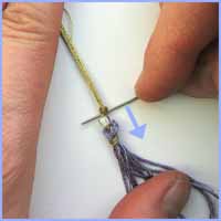 Slip the knot down so the bead fits snuggly between both knots