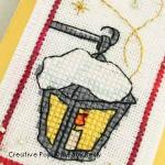 cross stitch patterns with  a lantern, a red robin, a snowman and stars. (zoom1)