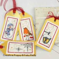cross stitch patterns with  a lantern, a red robin, a snowman and stars.